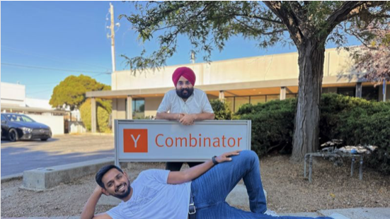 Mem0 founders posing by a Y Combinator sign